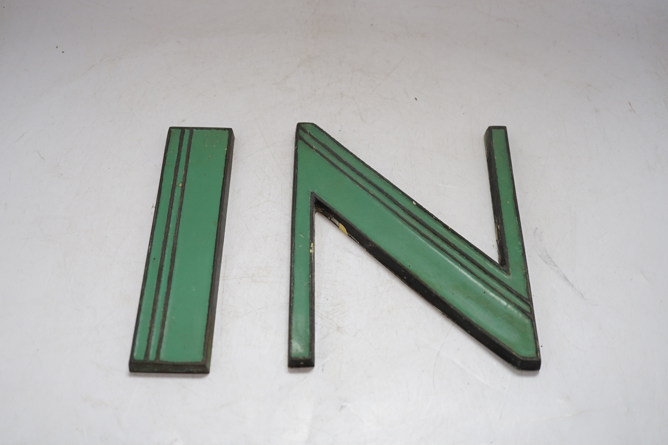 Art Deco green enamelled cast metal letters to spell ‘IN’ and ‘OUT’, 15cm tall. Condition - fair to good